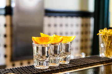 Shtof with strong alcohol and a slice of orange.