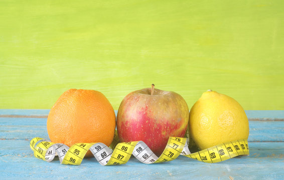 dieting concept with fruit and measuring tape, good copy space
