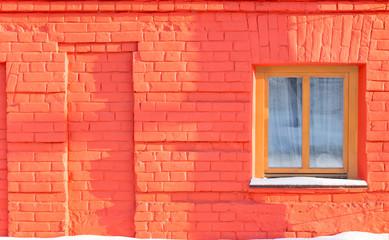 The window on the wall of red brick