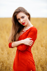 Portrait of a young brunette woman in red dress