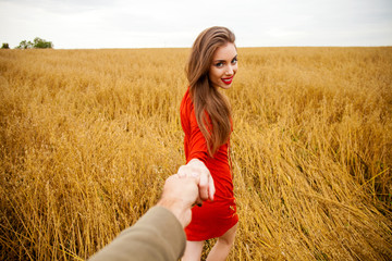 Follow me, Beautiful sexy young woman holds the hand of a man in