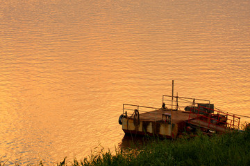 Fototapeta premium Old pier at the water bank, warm vintage tone color feel lonely