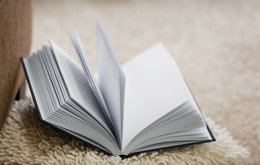 New opened book on pillow, closeup