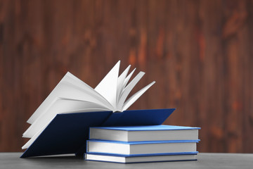 Pile of books on table and wooden background