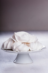 Fototapeta na wymiar Heap of fluffy meringue on the plateau