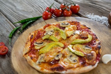 Various species with pizza arranged on wooden tray