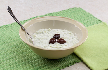 tzatziki sauce on a green placemat straw