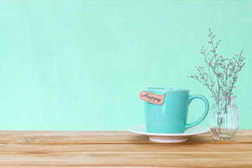 Coffee cup mug with happy word tag on wooden table , Romance