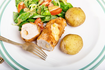 Kiev cutlet with jacket potatoes and salad