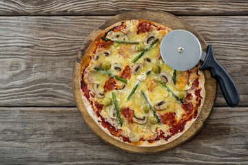 Italian pizza with pizza cutter on a tray