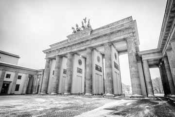 Naklejka premium Brandenburg gate (Brandenburger Tor) in snow, Berlin, Germany, Europe, Black and white 