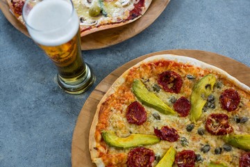 Italian pizza served with a glass of beer