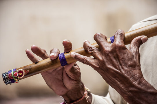 Hands playing flute - India 