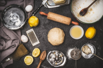 Fototapeta na wymiar Lemon Cookie or cake Dough with cooking ingredients and bake tools on dark rustic background , top view, flat lay