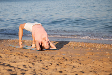 girl doing gymnastics in the morning on the Beach Ocean