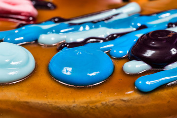 Birthday cake in the form of a paint palette with brushes