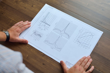Obraz premium Mechanical engineer at work. Technical drawings. Paper with technical drawings and diagrams.
