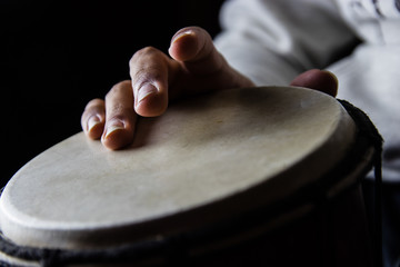 Playing African Drums in Low Key Single Light by Musician in Mus