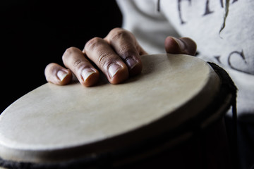 Playing African Drums in Low Key Single Light by Musician in Mus