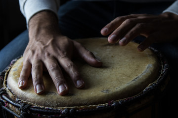 Playing African Drums in Low Key Single Light by Musician in Mus