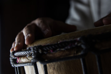 Playing African Drums in Low Key Single Light by Musician in Mus