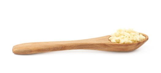Spoon of minced garlic isolated