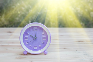 alarm clock with abstract nature bokeh blur background.