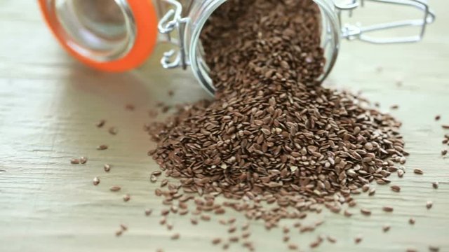 Flax seeds on painted wood board