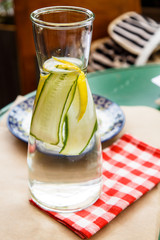 Lemonade with cucumber is poured into the bottle.