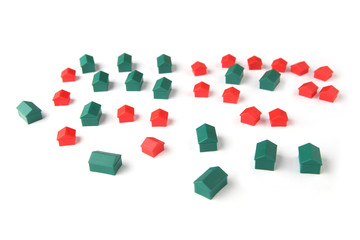 Plastic houses isolated on white background. Board game pieces.