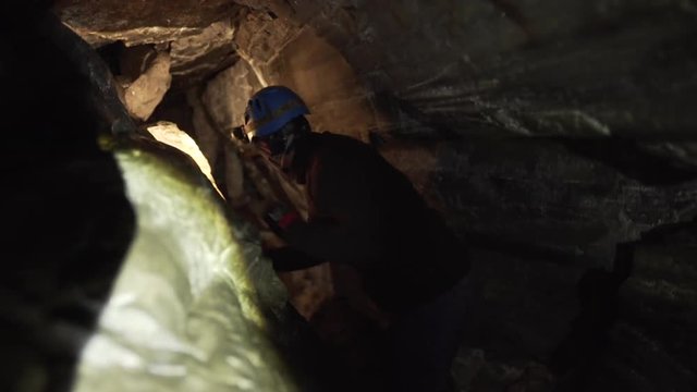 Explorer walking in a cave in Norway
