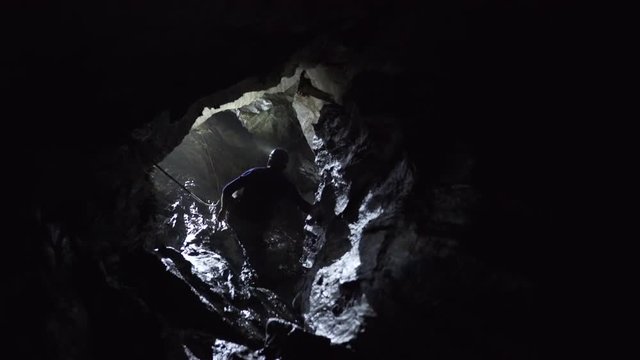 Explorer walking in a cave in Norway
