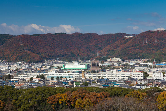 Himaji city downtown view from Himaji Castel with mountain background during Authum season