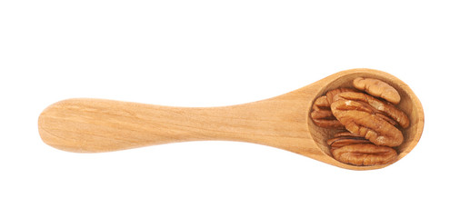 Spoon of pecan nuts isolated