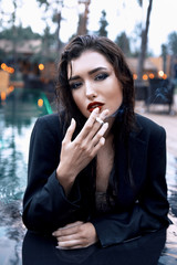 Fototapeta na wymiar Attractive wet woman smokes