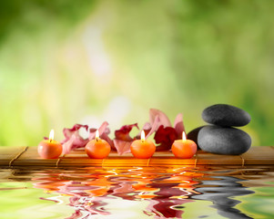 Beautiful spa composition with reflection on water surface
