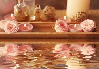 Beautiful spa composition with reflection on water surface