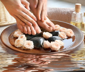 Young woman on spa procedure and reflection on water surface