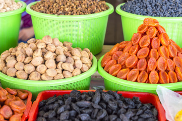 The stall with dried fruits at the Siab Dekhkhan Bazaar offers different raisins, apricots, prums and figs in Samarkand, Uzbekistan