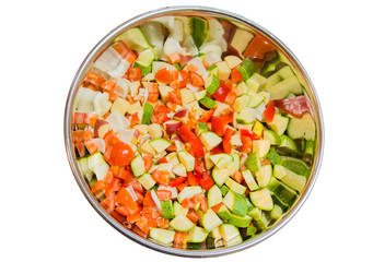 Salad of cucumber, onion and peppers tomatoes mixed in a large stainless bowl