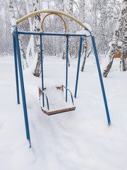 Swings covered with snow in the park