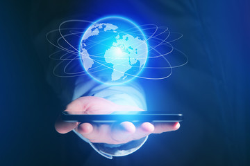 Businessman holding smartphone with globe sphere hologram going