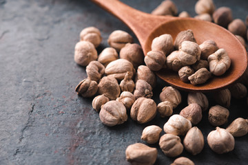 Placer white cardamom and wooden spoon close-up