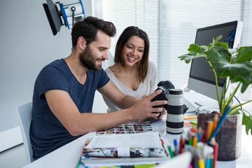 Photographers reviewing captured photos in his digital camera