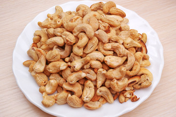 Heap cashew nuts on a white plate
