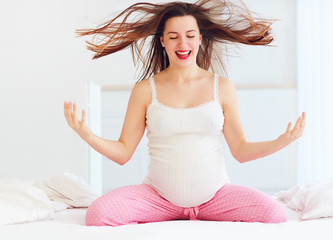 cheerful pregnant woman wakes up in the morning full of energy