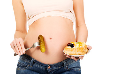 Pregnant woman with cake and pickle