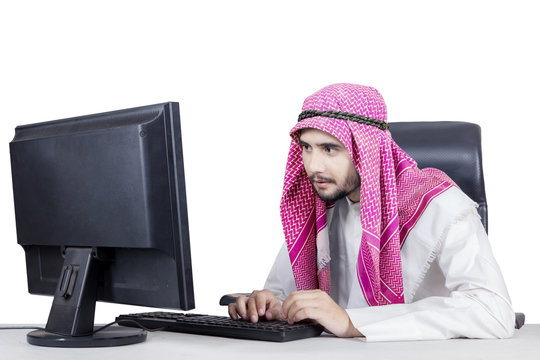 Arabian man typing on keyboard