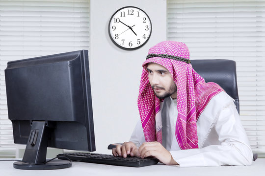 Arabian man working with computer