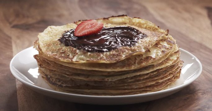 Slow motion of decorating blinis or crepes with fresh berries, 4k 60fps prores footage